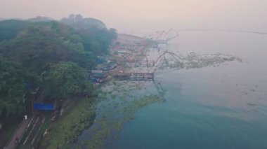 Traditional Chinese fishing nets in Fort Kochi at sunrise, India. Aerial drone view