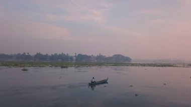 Fishing boat at sunrise in Fort Kochi, India. Low aerial drone