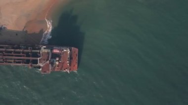Old shipwreck on a beach near Varkala in Kerala, India. Top down aerial drone view
