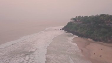 Varkala Beach at sunset in Kerala, India. Aerial drone view