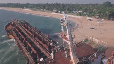 Shipwreck on a beach near Varkala in Kerala, India. Low aerial drone