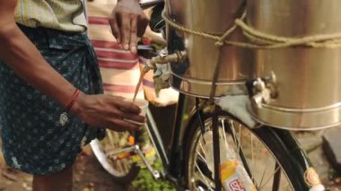 Indian Vendor Selling Hot Coffee Drink On A Bicycle In The Street Of Kochi, India. - close up shot