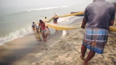 Local people fishing with traditional fishing nets, Kappil Beach, Varkala, India