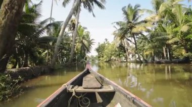 A Wooden Boat Sailing In The Brackish Water Of Kerala Backwaters Surrounded By Various Trees. -wide shot