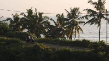 Fast Motorcycle Driving Near The Shore Of The Famous Varkala Beach In Kerala State, India. -wide shot