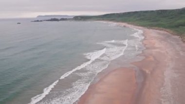 Stunning sandy beach, Antrim Coast of Northern Ireland. Aerial drone view