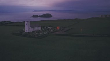 Church at night on the Antrim Coast of Northern Ireland. Aerial drone view