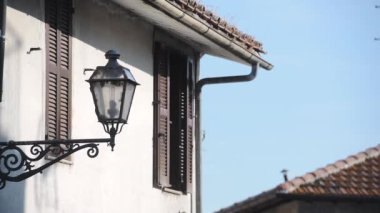 Traditional old street lamp on a historic building, Bracciano town, Italy