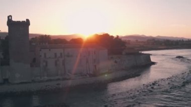 Santa Severa Beach and Castle at sunrise, Province of Rome, Italy. Aerial drone view
