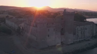 Santa Severa Beach and Castle at sunrise, Province of Rome, Italy. Aerial drone view