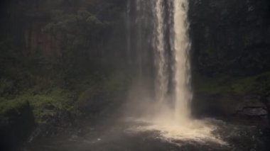 A beautiful waterfall by the forest in Aberdares, Kenya - wide shot