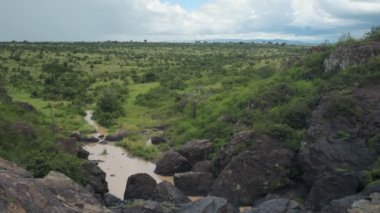 Landscape view over a river flowing through the Kenyan bush, Africa