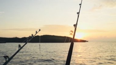 Deep sea fishing rod on a fishing boat at sunrise