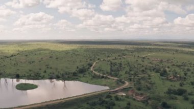 Waterhole lake in Laikipia, Kenya. High aerial drone view of Kenyan landscape
