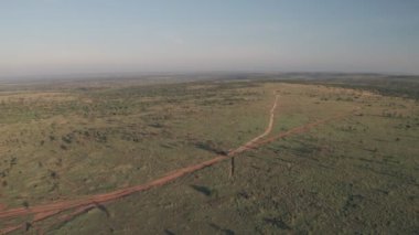 4 wheel drive vehicle on wildlife safari in Kenya. High aerial drone view