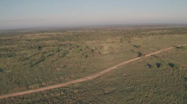4 wheel drive vehicle on wildlife safari in Kenya. Aerial drone view of safari holiday