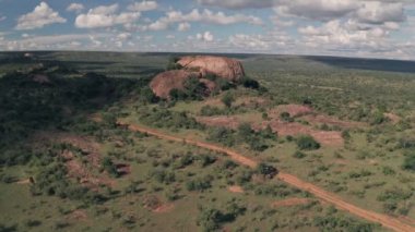 4 wheel drive on safari at Baboon Rock in Laikipia, Kenya. Aerial drone following