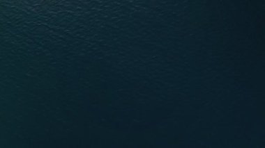 Deep sea fishing boat at sunrise in the Indian Ocean at Watamu, Malindi, Kenya. Top down aerial drone view