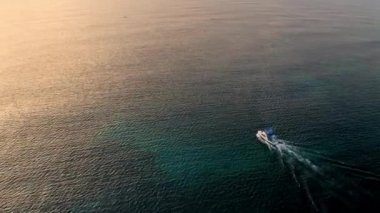 Deep sea fishing boat at sunrise in the Indian Ocean at Watamu, Malindi, Kenya. Aerial drone view