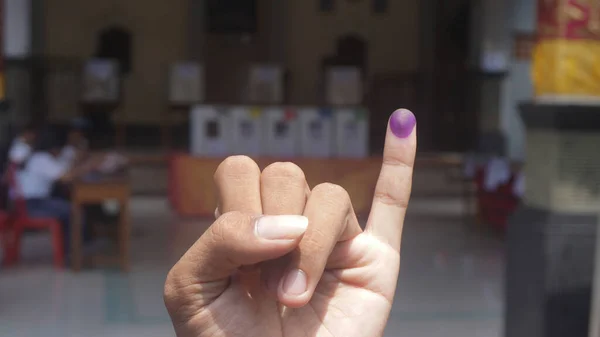 Purple ink on finger after presidential election in Indonesia.