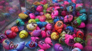 Bali, Indonesia - July 10, 2022: Hermit crab in a colorful form for sale. Painted to attract children's attention