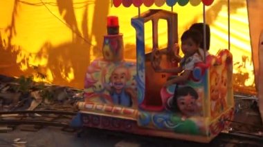 Bali, Indonesia - July 10, 2022: A ride on a children's train. Attraction in the amusement park. Children's railway in the amusement park for children. Train goes on rails. Train rides.