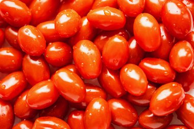 Red long tomatoes, top view. Food background.