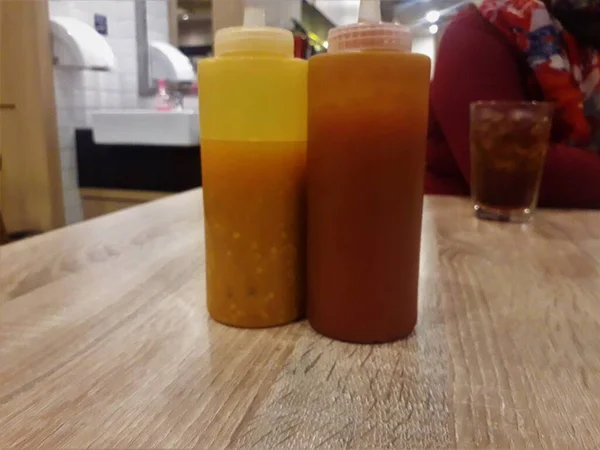 Two Bottles Chili Sauce Wooden Table — 图库照片