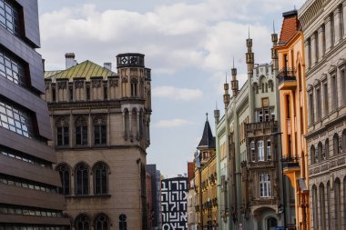 Old buildings on urban street with sky at background in Wroclaw clipart