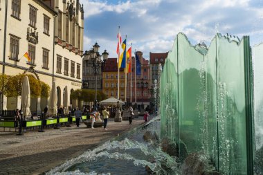 WROCLAW, POLAND - APRIL 18, 2022: Fountain on urban street at daytime  clipart