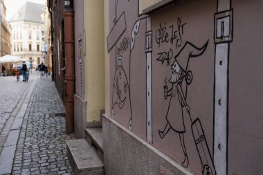 WROCLAW, POLAND - APRIL 18, 2022: Graffiti on facade of building on urban street  clipart