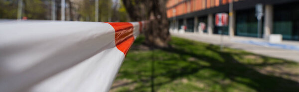 barrier tape on blurred unban street in Wroclaw, banner 
