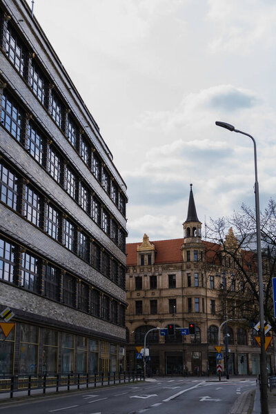 Buildings near empty road on urban street in Wroclaw