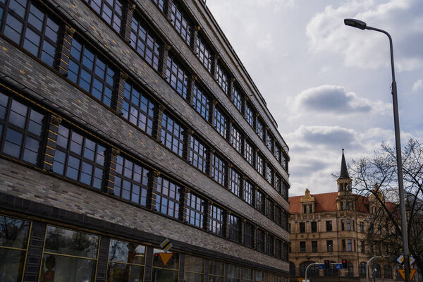 Buildings and city light on urban street in Wroclaw