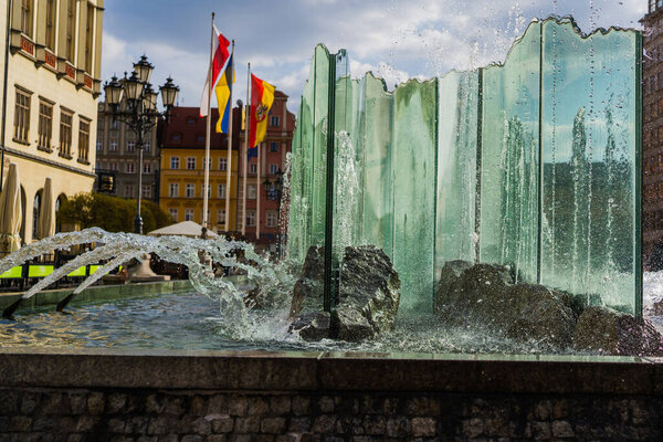 WROCLAW, POLAND - APRIL 18, 2022: Fountain on urban street at daytime 