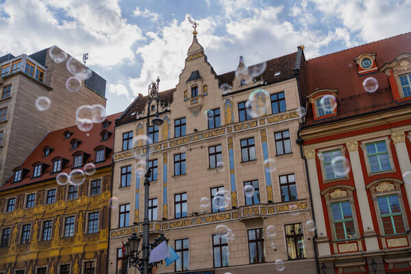 Low angle view of blurred soap bubbles on urban street in Wroclaw