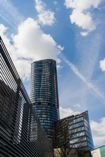 WROCLAW, POLAND - APRIL 18, 2022: Low angle view of sky tower on urban street 