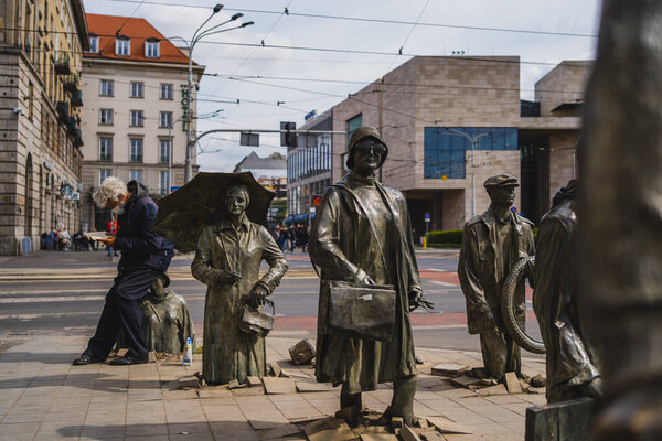 WROCLAW, POLAND - APRIL 18, 2022: View of sculptures of Anonymous Pedestrians on urban street 