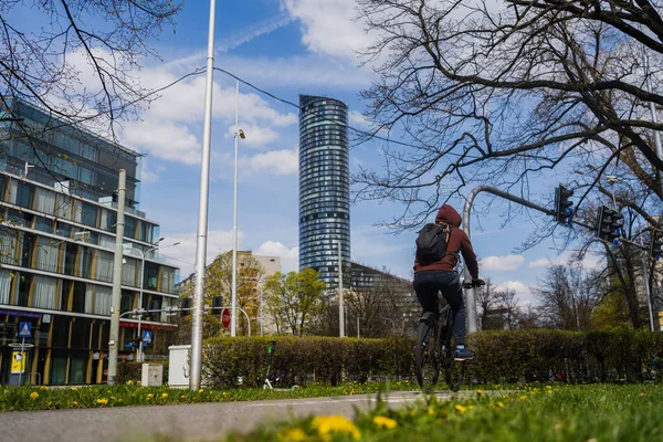 Back view of man riding bike on urban street in Wroclaw — Stock Photo