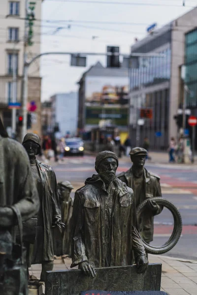 WROCLAW, POLAND - APRIL 18, 2022: Bronze statues of Anonymous Pedestrians memorial on urban street — Stock Photo