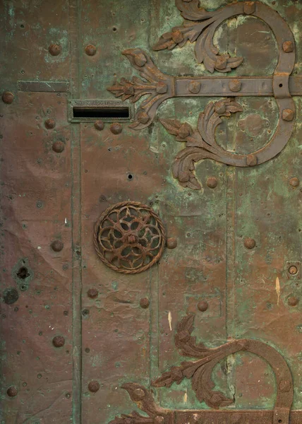 detail of an old bronze door with detail in Italy