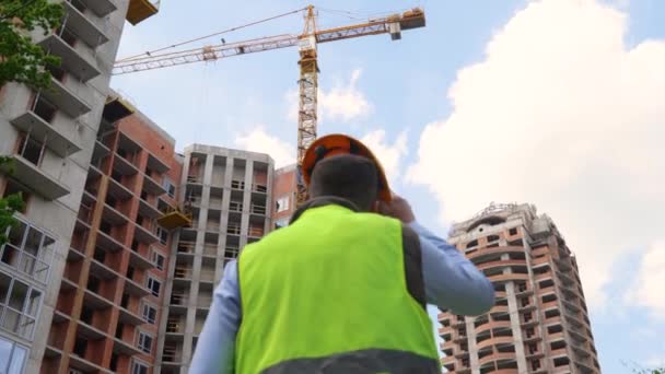 Back View Man Builder Standing Front Construction Site Looking Building — Stock video