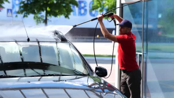Young Caucasian Male Worker Washing Car Holding Hand Hose High — Stockvideo