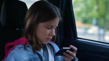 Arabasında oturan ve akıllı telefonlara mesaj atan güzel, beyaz bir kızı yakından çek. Cep telefonunda gezinen çocuk. Araçtaki aile gezisinde cep telefonu dinleyen gençler. Teknoloji, gezi konsepti
