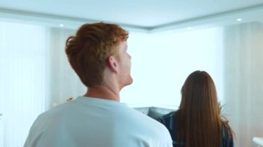Close up of young married couple moving in together in own apartment. Boyfriend and girlfriend entering the room and hugging feeling happy in new home. Marriage concept. Mortgage loan. Family couple