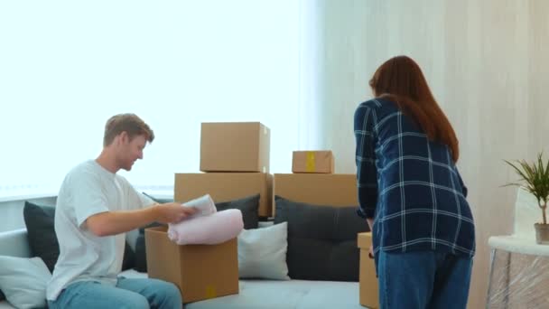 Happy Young Caucasian Couple Unpacking Stuff Cardboard Boxes New House — Stok Video