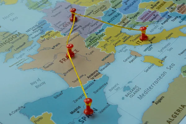 Spain Germany Italy and France on map with red fastener, Europe travel route on map with red thumbtack, travel idea, vacation and road trip concept, Europe destination, top view, selective focus