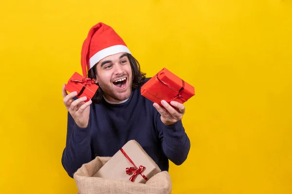 Young Man Santa Claus Hat Shows Happy Christmas Gifts Yellow — Stock Photo, Image
