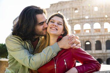Roma 'ya seyahat eden genç bir çift. Çift Colosseum 'un önünde öpüşüyor..