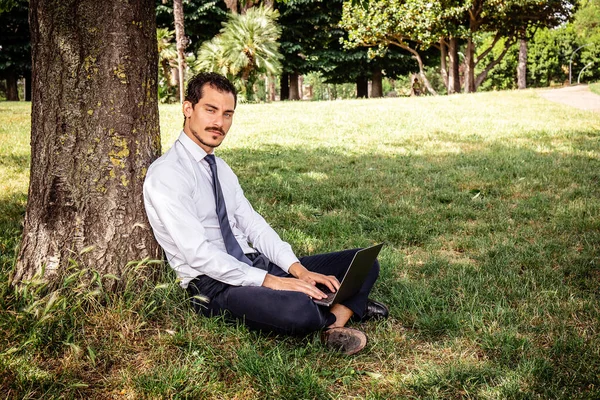 Beautiful Businessman Working Park Young Businessman Sitting Lawn Leaning Tree Fotos de stock